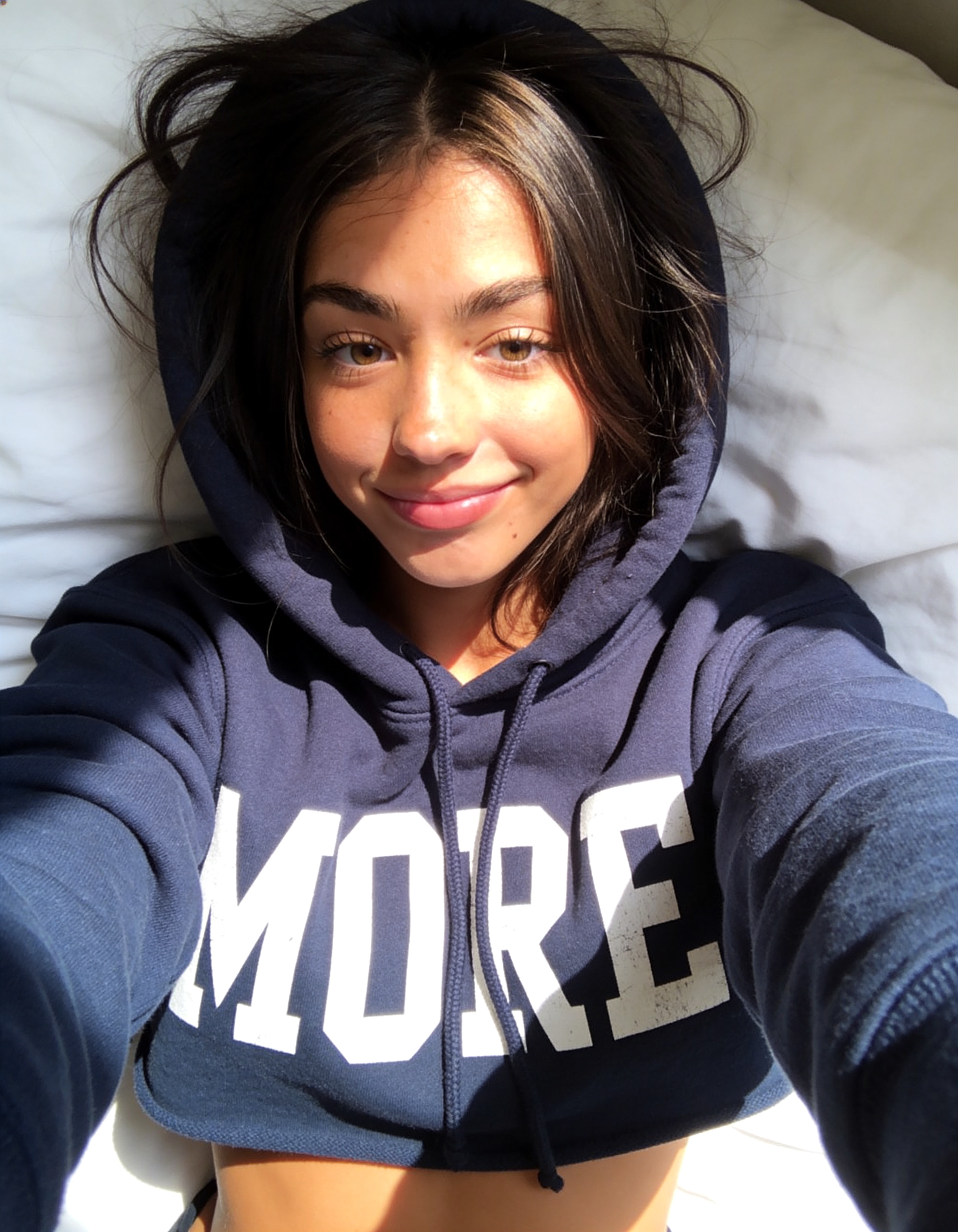 Ana smiling in a navy hoodie
