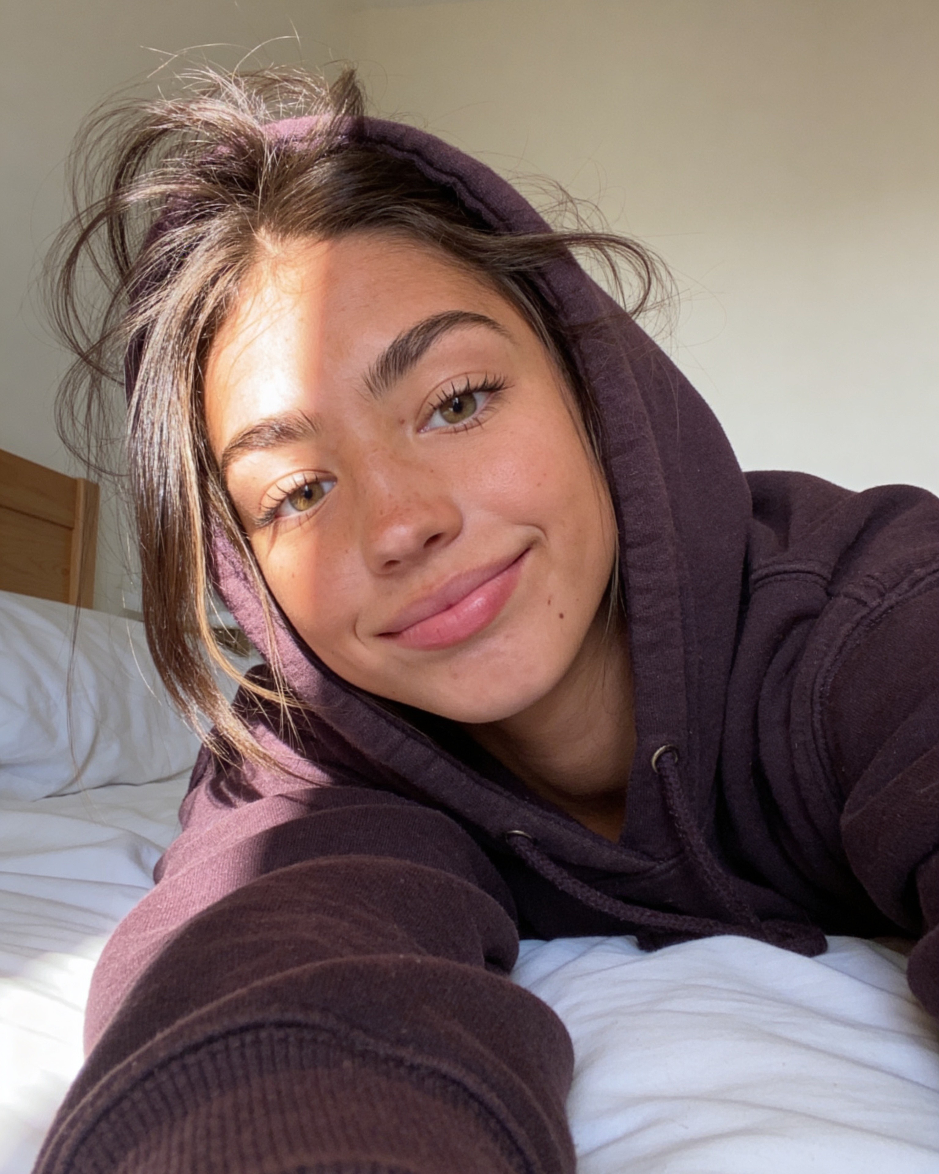 Ana smiling in a hoodie